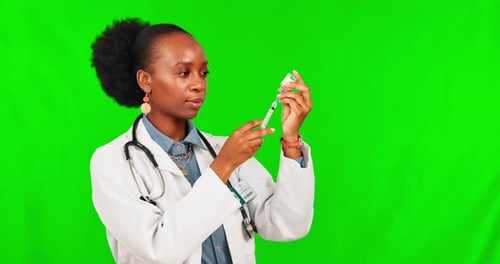 Vaccine, smile and a doctor black woman on a green screen background in studio for healthcare