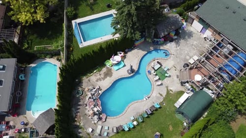 Aerial view of swimming pools in the backyards of houses 4K