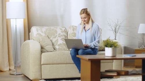 Blonde Woman Working on Laptop at Home