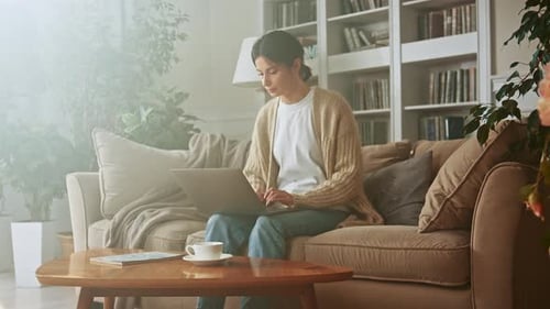 Woman Working on Laptop at Home