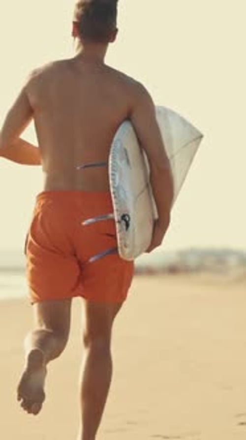 Surfer Running on the Beach with Surfboard