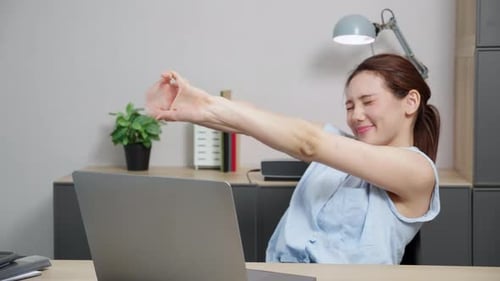 Portrait young caucasian businesswoman taking a break after overworked with stretching arm and hand.