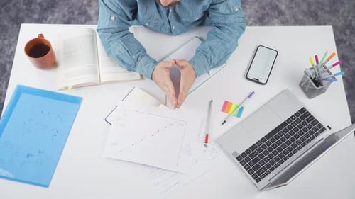 Person Working at White Desk with Technology