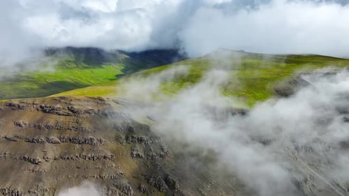 Flying Through Clouds Above Green Hills Paradise Heaven Mountain Range with High Peaks Wonderful