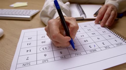 Planning and Scheduling with Calendar and Notebook at Desk