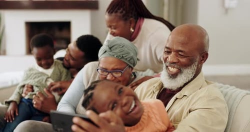 Happy Family Laughing Together on Couch