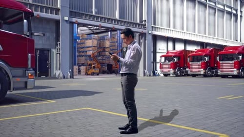 Asia Male Use Phone, Outside Warehouse