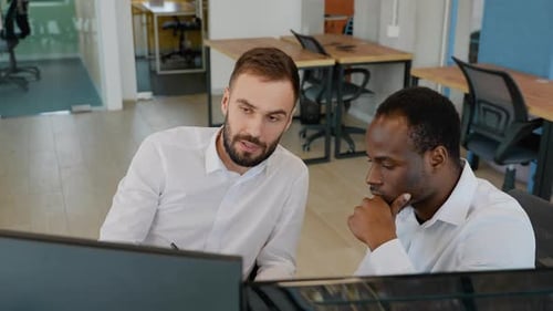 Two Stock Traders Working in the Office with Exchange Technology