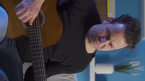 Man Playing Acoustic Guitar, Mid Shot