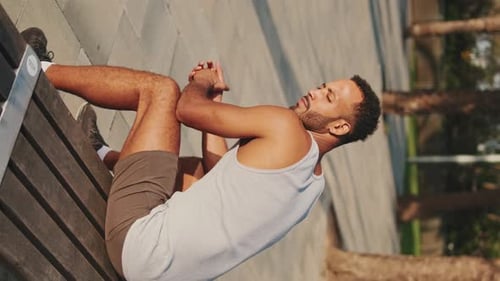Young Adult Man Doing Tricep Dips on Bench