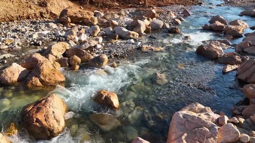 Aerial Drone Top Down View at Strong Streams of Cold Clean Water is Flowing Over Stones