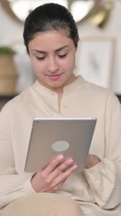 Woman Interacts with a Tablet in Residential Setting