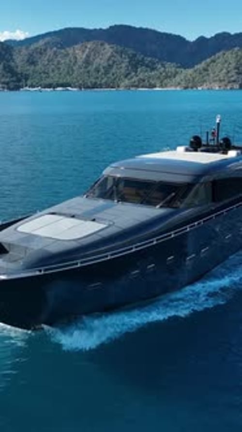 Luxury Yacht Sailing the Open Sea: A sleek and modern luxury yacht slices through the sparkling turq