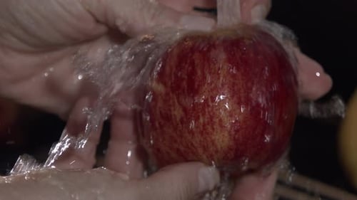 Apple Being Washed Under Running Water