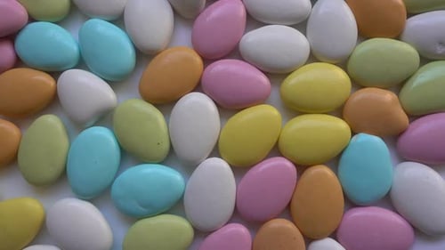 Pile of almonds or colored pine nut almonds. Easter season.