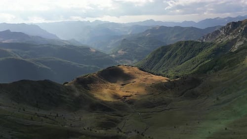 A Drone Flies Along a Picturesque Mountain Valley Illuminated By the Setting Sun