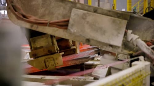 Robotic stands remove hot metal plates and place them in a cooling vessel