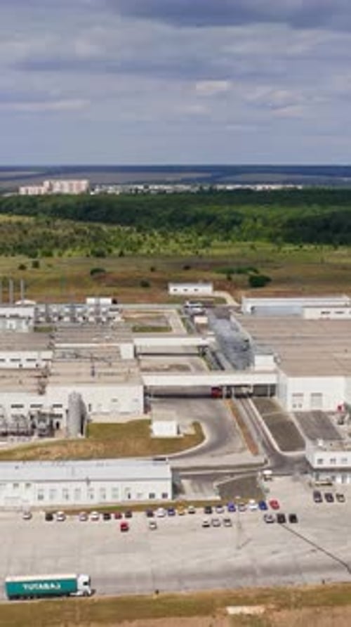 Modern technology manufacturing plant. Drone view of manufacturing area in field. Vertical video