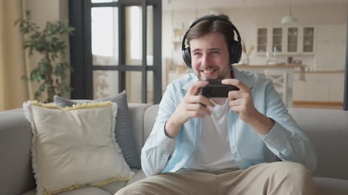 Young Adult Enjoying Video Game on Console