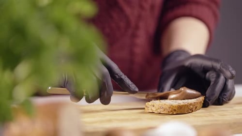 Close-Up of Chef Spreading Creamy Chocolate on Whole Grain Bread