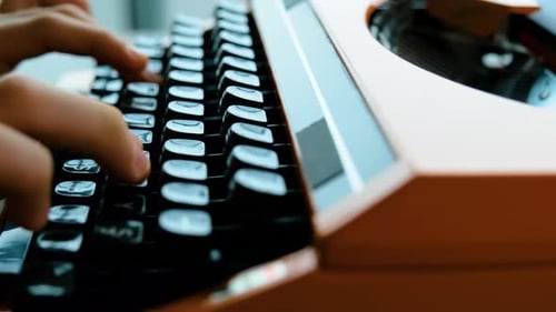 Writing letters with orange retro vintage typewriter