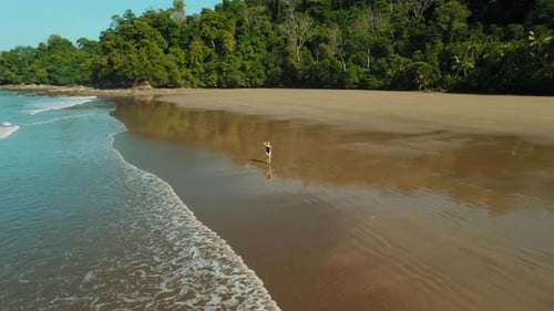 Solo traveler woman on Playa Arco Costa Rica walking at low tide in morning light