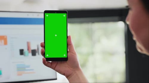 Woman Holds Smartphone at Desk