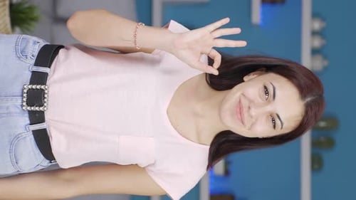 Smiling Woman Gives Thumbs Up and Ok Sign
