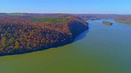 Aerial View of Autumn Tree Colors Along a Major River on a Sunny Fall Day