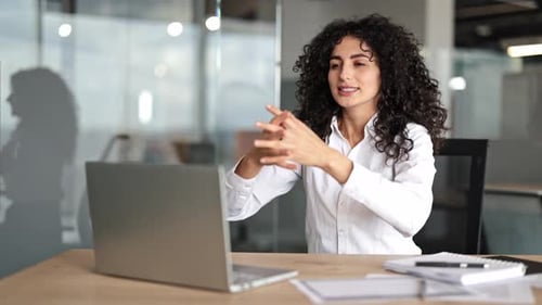 Young Businesswoman Stretching at Work in a Modern Office