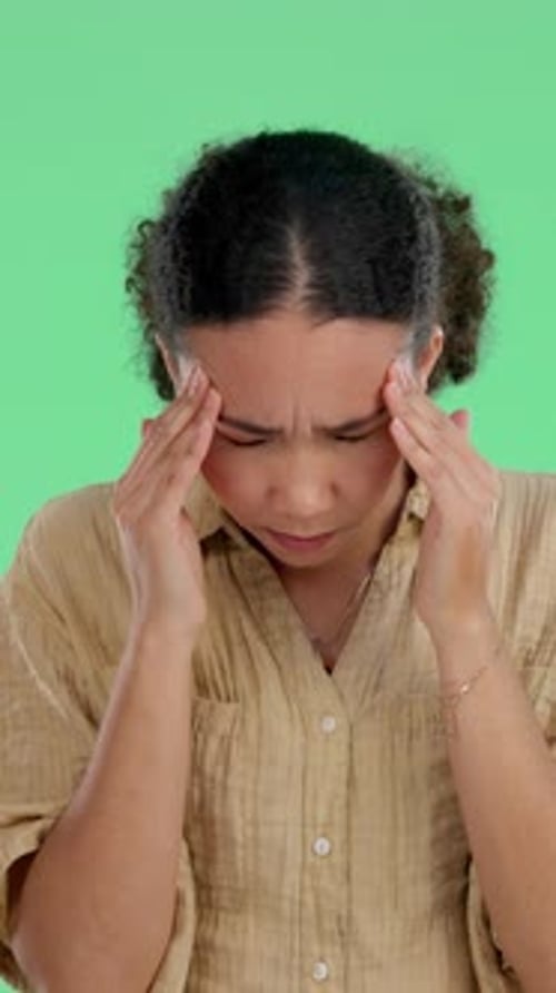 Headache, green screen or woman in studio with massage, overwhelmed or burnout in healthcare risk