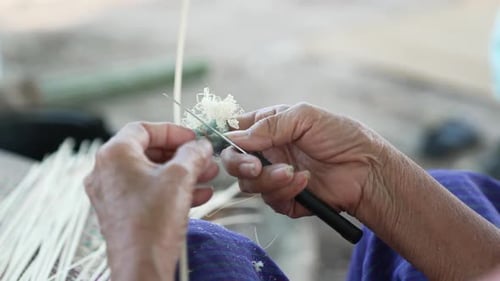Slow Motion Scraping Off Bamboo Sticks with a Knife, Skillful Bamboo Weaving, Close Up