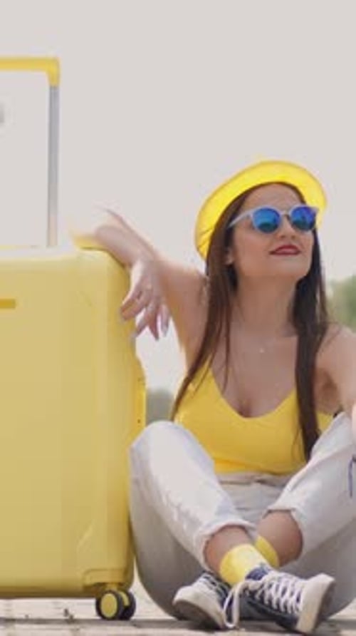 On a Bright and Sunny Day a Young Woman Enjoys Her Time at the Lively Train Station Happily Waiting