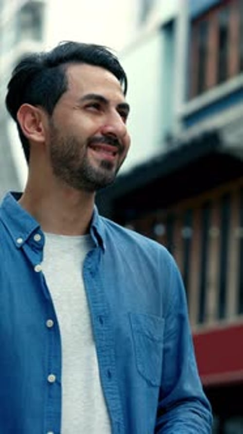 Portrait of Bearded Middle Eastern Man Takes Picture with Camera in Old Town