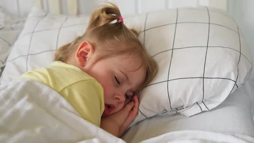Blond Child Sleeping Peacefully in Bed at Home