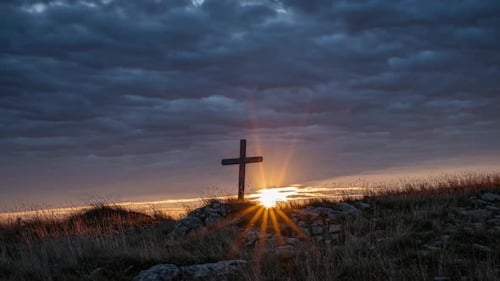 Rugged Cross on a Rocky Hill with Golden Sunlight