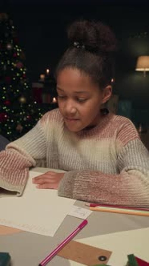 Black Girl Child Writing Letter to Santa on Xmas Eve at Home