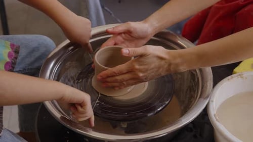 Creating Pottery on the Wheel in a Studio with Children in the Afternoon