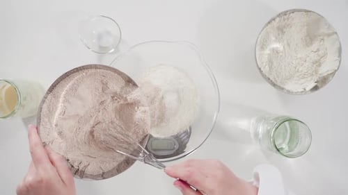 Chef mixes flour in a bowl on table