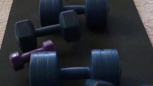 Weight lifting tools falling on the gym mat