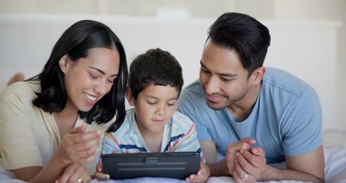 Family Together on Bed Using Tablet Device