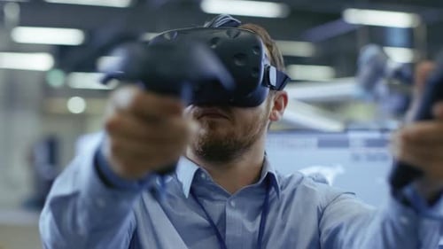 Portrait Shot of the Industrial Engineer Wearing Virtual Reality Headset and Using Controllers, rea