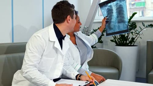 Medical Team Reviewing X-Ray in Hospital Setting