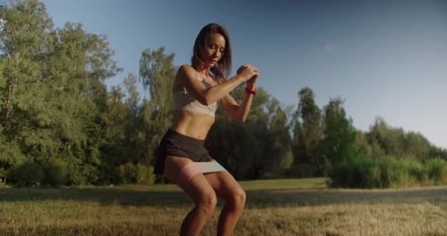 Woman Exercising with Resistance Band Outdoors
