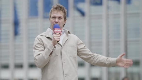 Professional Journalist Covering News Events Outside a Corporate Building Providing Live Reporting