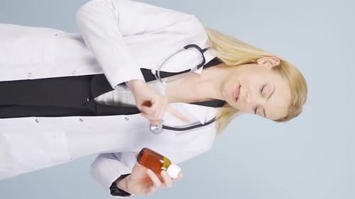 Doctor Presenting Dosage Information with Amber Bottle