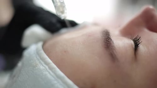 Woman Receives Cosmetic Treatment on Forehead