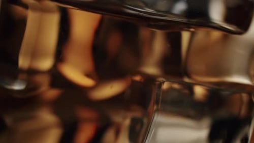 Close Up of Refreshing Carbonated Cola Pouring Over Ice Cubes