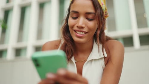 Woman Uses Mobile Phone Outdoors in Urban Setting