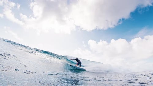 Surfer Rides the Wave in the Maldives During Sunny Day